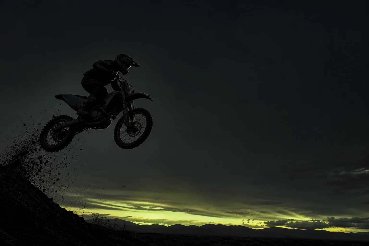 Rider jumping at dusk